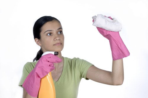 Trained technician using cleaning equipment with safety precautions